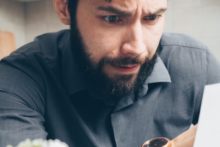 Man in Black Long Sleeve Shirt Wearing Gold Watch