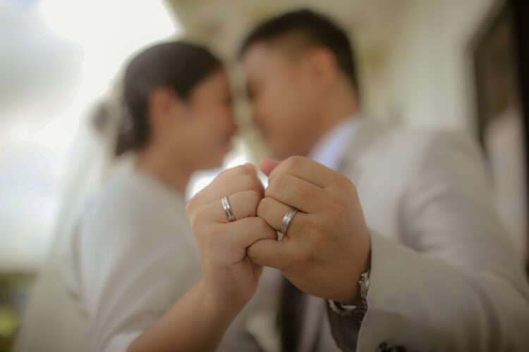 a man and a woman holding hands in front of a mirror