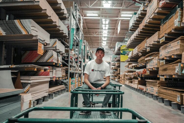 man sitting on gray trolley